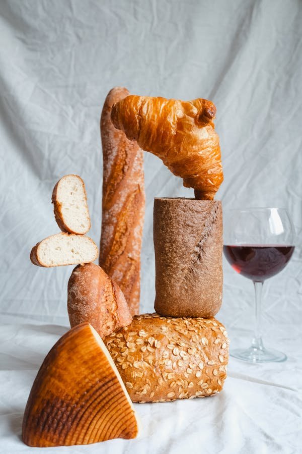 free-photo-of-cheese-and-red-wine-glass-by-display-of-bread
