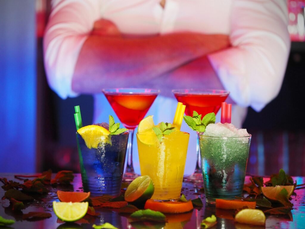 pexels-photo-110472-110472 Colorful cocktails with citrus slices on a bar, perfect for nightlife settings.