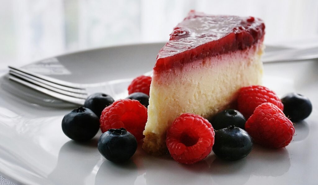 pexels-photo-1126359-1126359 A tempting slice of cheesecake topped with berries, perfect for dessert lovers.