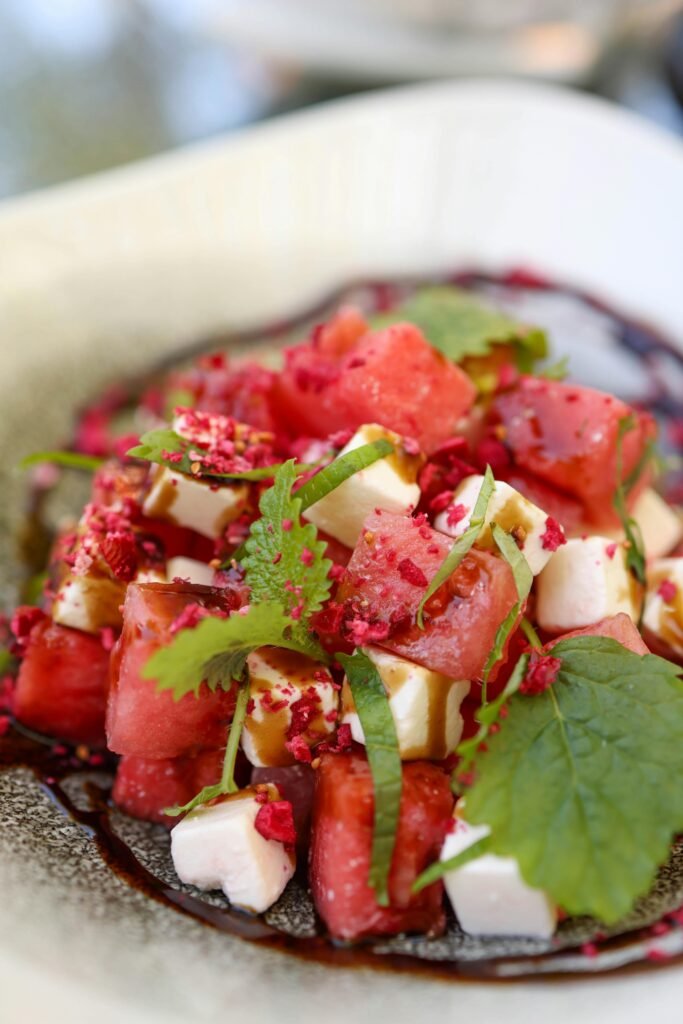 pexels-photo-16966980-16966980 A deliciously vibrant watermelon feta salad garnished with mint leaves.