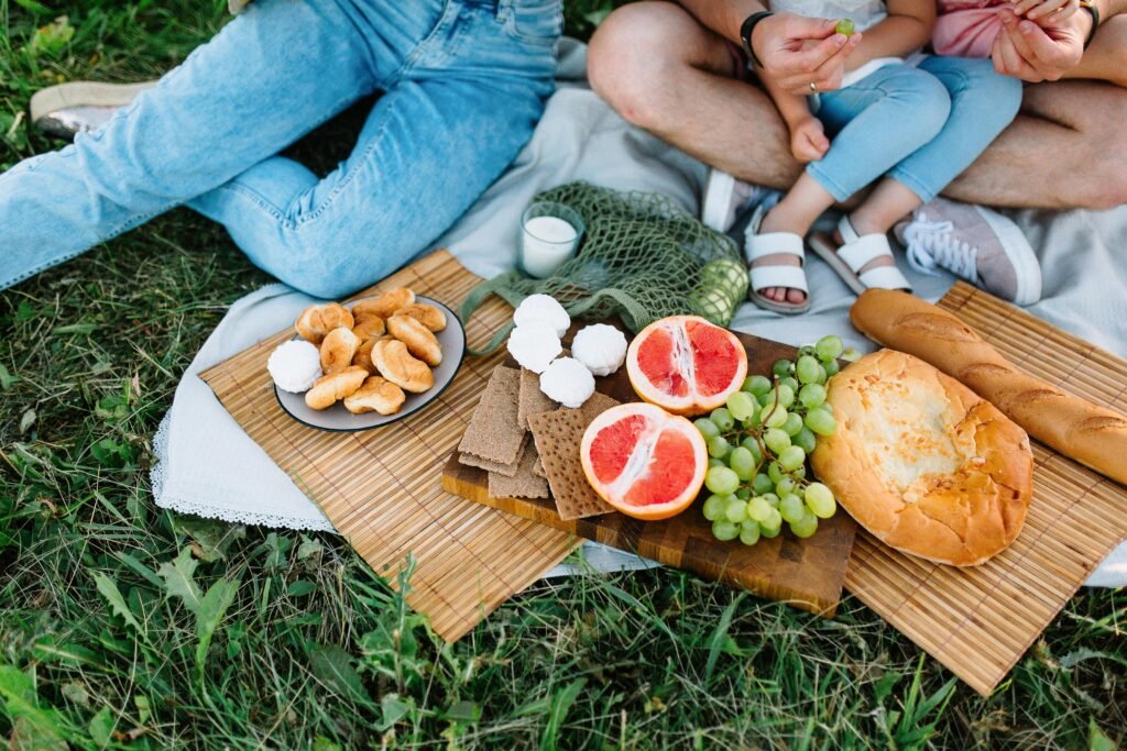 pexels-photo-8569162-8569162 Enjoy a summer picnic featuring fresh grapes, grapefruit, and assorted breads.