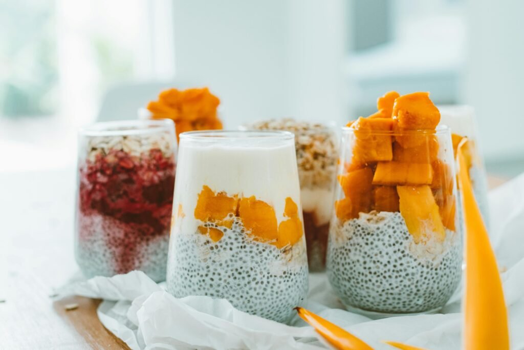 Delicious chia pudding parfaits topped with vibrant, fresh fruits and yogurt.
