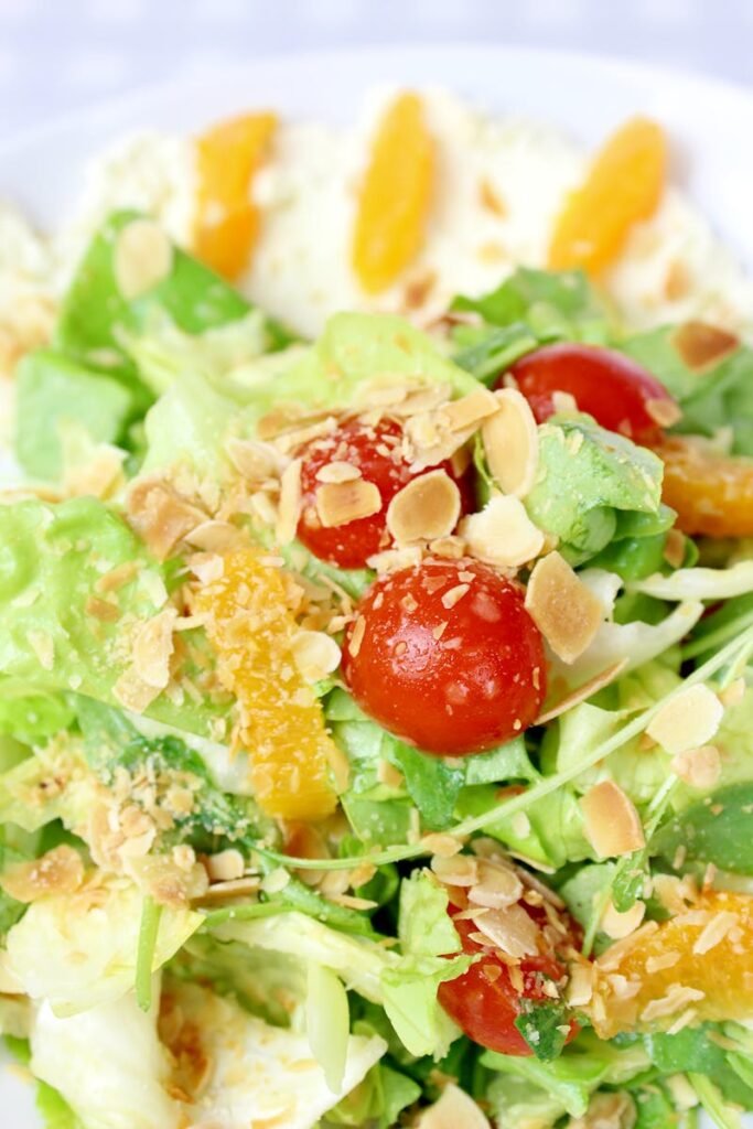 pexels-photo-6468561-6468561 Colorful fresh salad with cherry tomatoes, almonds, and citrus dressing. Ideal for healthy eating.
